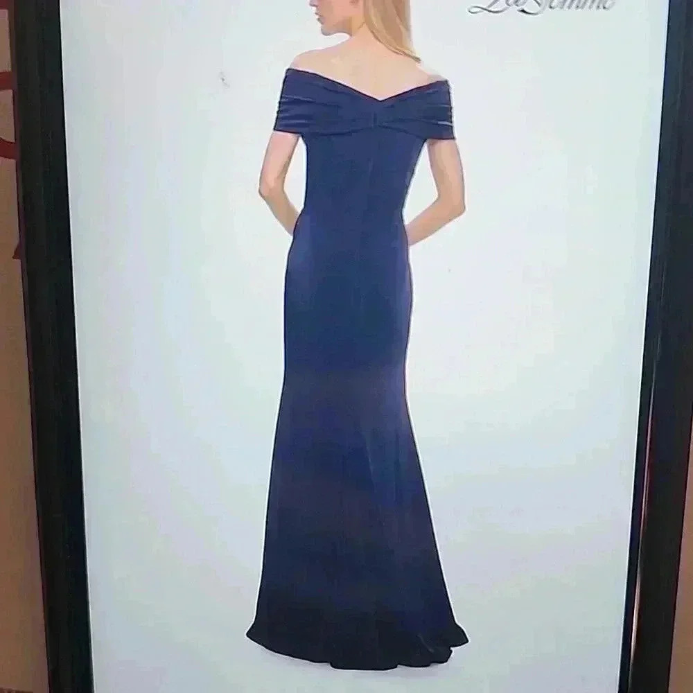 La Femme Evening navy gown with long skirt and pleating alone neckline.